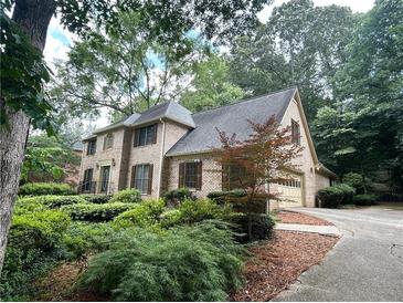 Charming brick home with mature landscaping and a side-entry garage at 4116 River Cliff Chase Se, Marietta, GA 30067