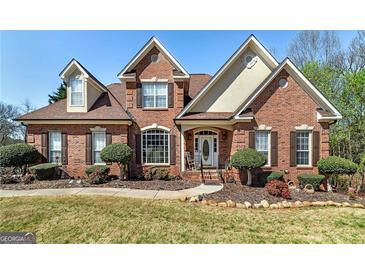 Charming two-story brick home with a manicured lawn and inviting front entrance with a portico at 149 Crown Glen Way, Stockbridge, GA 30281