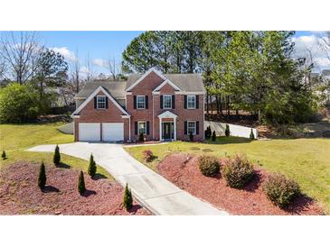 Beautiful two-story brick home with a two car garage, a long driveway, and luscious landscaping at 949 Tumlin Trce, Lawrenceville, GA 30045