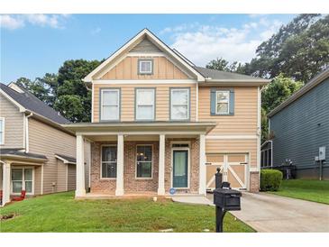 Charming two-story home featuring a welcoming front porch and well-maintained lawn in a residential neighborhood at 1777 Meadow Sw Ln, Atlanta, GA 30315