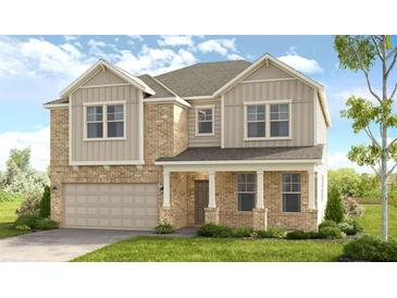 Two-story home featuring a brick and vinyl exterior, attached two-car garage, a front porch, and manicured lawn at 82 Sheryl Way, Loganville, GA 30052