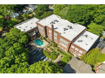 Aerial view showcases brick building with pool and verdant landscaping at 1041 State Nw St # 23, Atlanta, GA 30318