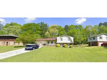 Charming single-Gathering home featuring a spacious front yard and mature trees in a serene neighborhood at 4218 Carlos Ct, Powder Springs, GA 30127