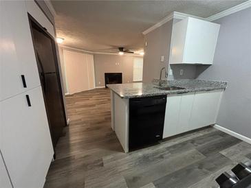 Galley kitchen features granite counters, ample storage, and is open to the living area at 6353 Wedgeview Ct, Tucker, GA 30084