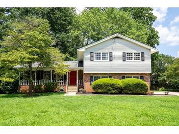 Charming two-story home with a brick facade, well-manicured lawn, and mature trees at 1831 Galilee Ct, Tucker, GA 30084
