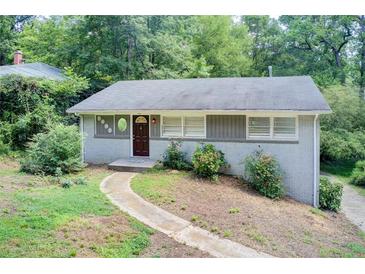 Charming single story home with brick exterior and landscaped front yard nestled among mature trees at 1834 Buckeye Sw St, Atlanta, GA 30310