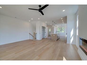 Bright and airy living room featuring hardwood floors, recessed lighting, and an open floor plan with kitchen view at 1919 Deco Dr, Kennesaw, GA 30144