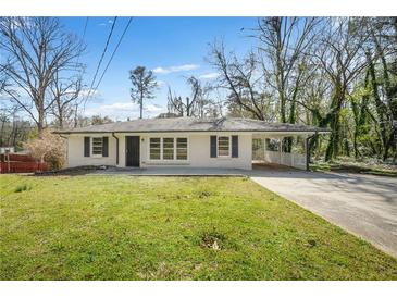 Charming single-story home featuring a carport, a well-maintained lawn, and classic curb appeal at 2703 Flagstone Dr, Atlanta, GA 30316