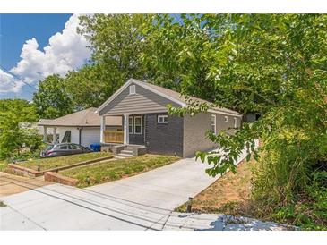 Charming home featuring a brick facade, freshly painted with a new front porch and updated landscaping at 299 Fletcher Sw St, Atlanta, GA 30315