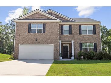 Charming two-story brick home featuring a two-car garage, dark shutters, and a well-manicured lawn at 450 Noblewood Dr, Mcdonough, GA 30252