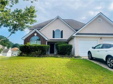 Charming two-story home with manicured lawn and attached garage, perfect for suburban living at 15 Emerson Trl, Covington, GA 30016