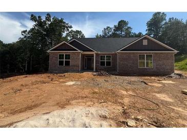 Traditional brick home with a contemporary roof and trim awaiting landscaping at 5381 Tuscany Dr, Douglasville, GA 30135