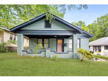 Charming home featuring a covered porch, brick facade, and well-maintained front yard at 531 Atlanta Se Ave, Atlanta, GA 30315