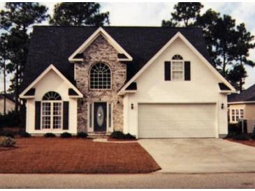 Charming two-story home featuring stone accents, a two-car garage, and a well-manicured front lawn at 2557 Casablanca Dr, Conyers, GA 30012