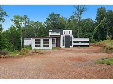 Modern home with black and white accents and spacious lot surrounded by lush greenery at 5210 Brownlee Rd, Stone Mountain, GA 30087