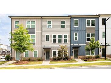 Modern townhome features colorful siding, manicured landscaping, and inviting entrances at 1190 Buice Lake Pkwy, Acworth, GA 30102