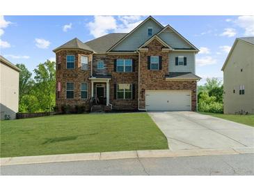 Charming two-story brick home featuring a well-manicured lawn and two-car garage at 5345 Mirror Lake Dr, Cumming, GA 30028