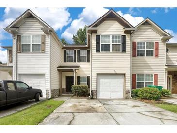 Charming townhome features varied shutters, attached garages, and inviting curb appeal at 1540 Rogers Preserve Rd, Lithonia, GA 30058