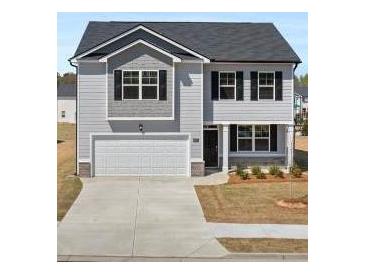 Charming two-story home featuring a two-car garage and classic architectural details at 8587 Secretariat Dr, Lithonia, GA 30058