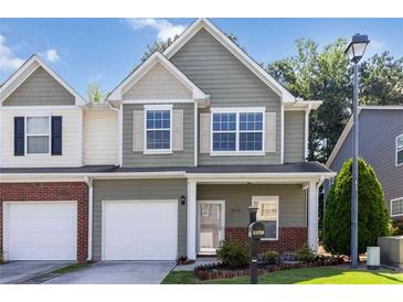 Charming two-story townhome with a well-manicured front yard and attached garage at 3170 Cedar Glade Ln, Buford, GA 30519