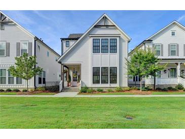 Charming two-story home with white siding, black framed windows and well-manicured lawn at 3415 Crop Corner Rd, Suwanee, GA 30024
