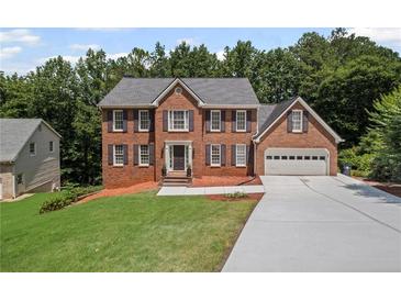 Charming two-story brick home with a well-manicured lawn and a spacious driveway at 1079 Angel Ln, Powder Springs, GA 30127