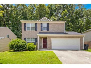 Charming two-story home with brick facade, blue shutters, and well-maintained front lawn at 5622 Laurel Ridge Dr, Atlanta, GA 30344