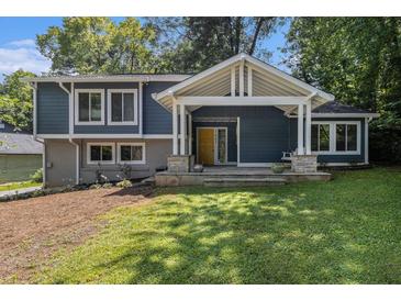 Charming two-story home with a welcoming front porch, blue siding, and well-maintained lawn at 1621 Northlake Springs Ct, Decatur, GA 30033