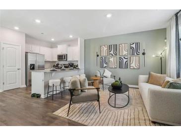 Bright and airy living room showcasing modern decor and an open concept connecting to the kitchen at 1402 Sweetshrub Pl # 32, Atlanta, GA 30318