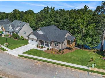Beautifully landscaped house with an attached two-car garage and a cozy side porch overlooking the lake at 301 Retreat Way, Carrollton, GA 30116