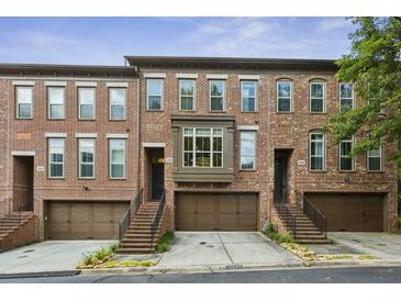 Charming brick townhomes featuring attached garages and inviting staircases at 2442 Crescent Park Ct, Atlanta, GA 30339