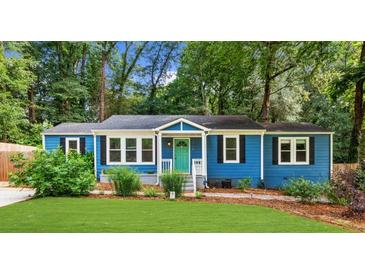 Charming blue home with a well-maintained front yard and a vibrant turquoise front door at 1718 Cahoon Sw St, Atlanta, GA 30310