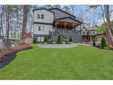 Charming two-story home with a large lawn and a stylish gray exterior at 2497 Wawona Dr, Brookhaven, GA 30319