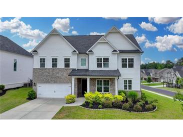 Charming two-story home with a landscaped yard, brick accents and a two car garage at 3695 Andover St, Cumming, GA 30028