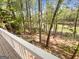 Backyard featuring lush greenery, mature trees, and stairs leading down to a pond at 819 Bermuda Run, Woodstock, GA 30189