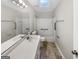 Bathroom featuring a large mirror, vanity sink, toilet, bathtub and shower with accessibility features at 819 Bermuda Run, Woodstock, GA 30189