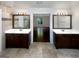 Luxurious bathroom featuring dual vanities, decorative mirrors, and elegant tile flooring at 819 Bermuda Run, Woodstock, GA 30189