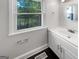 Bathroom with vanity, white cabinets, and a double hung window at 819 Bermuda Run, Woodstock, GA 30189