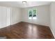 Bedroom with hardwood floors, a closet, and a double hung window at 819 Bermuda Run, Woodstock, GA 30189