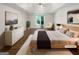 Staged bedroom with hardwood flooring, a trey ceiling, and bright natural light from the window at 819 Bermuda Run, Woodstock, GA 30189