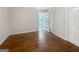 Bright bedroom featuring gleaming hardwood floors, neutral walls, and an abundance of natural light from the door at 819 Bermuda Run, Woodstock, GA 30189