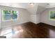 Bedroom featuring hardwood floors, a window with a view of the neighborhood, and sloped ceilings at 819 Bermuda Run, Woodstock, GA 30189