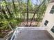 Wooden deck overlooking a lush green backyard with mature trees and a view of the water at 819 Bermuda Run, Woodstock, GA 30189