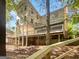 Back view of a two-story home with decks and a wooded lot at 819 Bermuda Run, Woodstock, GA 30189