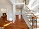 Inviting foyer with hardwood floors and a staircase with decorative iron railings and wood banister at 819 Bermuda Run, Woodstock, GA 30189