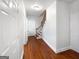 Hallway showcasing hardwood flooring, fresh paint and a staircase leading to the second floor at 819 Bermuda Run, Woodstock, GA 30189