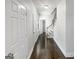 Hallway with wood floors and white doors provides seamless transition throughout the home at 819 Bermuda Run, Woodstock, GA 30189