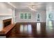 Spacious living room with hardwood floors, large windows, and a cozy fireplace at 819 Bermuda Run, Woodstock, GA 30189