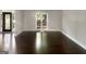 Living room with wood floors, a front door, and a large window at 819 Bermuda Run, Woodstock, GA 30189