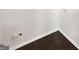 A view of a section of a utility room or closet, with an electrical outlet and dark floors at 819 Bermuda Run, Woodstock, GA 30189